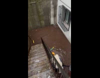 Man unclogs drainage on the flooded basement