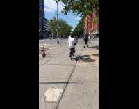 Man ride bike on sidewalk carry appliance