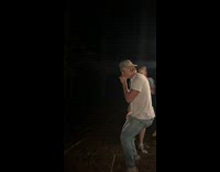 Guy jumps through tree stump at night