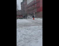 Guy on skis pulled by SUV on road