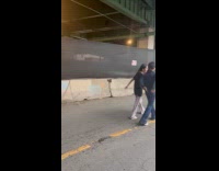 People under bridge take shelter from rain