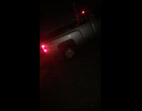 Silver truck does burnout outside 