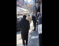 Man wears coat full of coffee cup