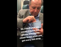 man in suit eating ice cream