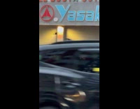 Two guys carry McDonalds sign on street part 1