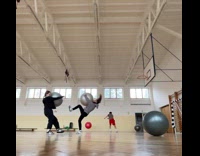 Two women run towards with yoga ball
