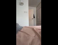 Woman taps bed then cat climbs up