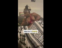 Guy drinks alcohol then reacts to someone in kitchen 