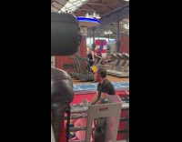 Woman holds onto side rails, holds body up and runs on treadmill in the gym