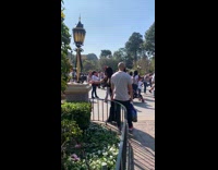 Girl takes picture at Disneyland
