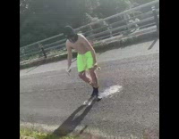 Guy in balaclava mask pours beer all over himself and jumps off bridge