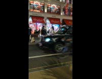 Woman in white jacket poses in the middle of the street