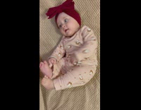 Baby waves and kicks her arms and legs 