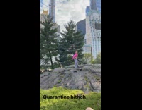 Pink shirt girl looks back grey rock 