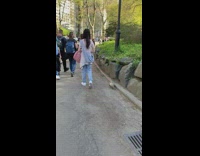 Girl walks ferret on pink leash at park