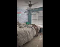 Really long bed in middle of room in front of tv 