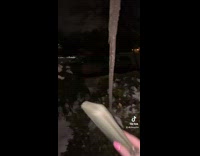 Girl breaks icicle with wallet 