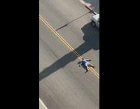 Guy blue shirt shades lay middle street