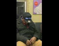 Guy sleeping on subway train wears that says Im not lazy im on energy saving mode
