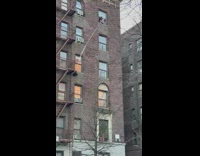 Person pulls backpack with rope into window 