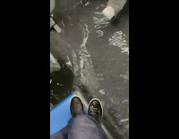 Man stands on bus seat avoiding flood