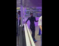 Woman in Catwoman costume rollerskating rink