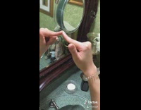 Girl mirror illusion finger phone mouth bathroom