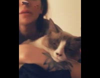 women with cat filter and cat laying on her