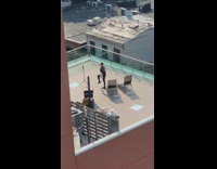 Woman with a sunhat and handbag rooftop photoshoot