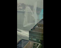 Police procession on river with boat shooting water out