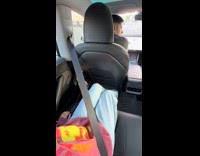 Man reaches back for seatbelt
