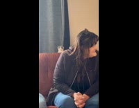 Kitten sitting behind couch watching house guests