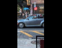 Guy sings karaoke while driving around city