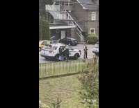 Old woman being arrested by police put in car 