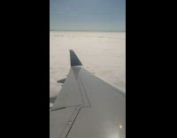 View of the clouds on an airplane window above