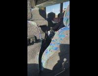 Guy hangs tablet on back of bus seat