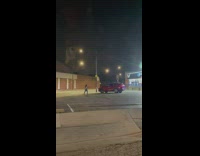 Guy stand over red car night parking lot