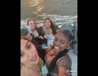 Four girls trying to take selfie picture pretty view