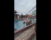 Guy asks worker to spray him in the face with water gun