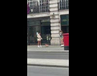 Girl skate shoes hold dog outside store