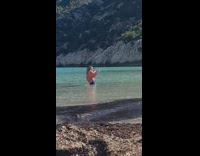 Girl baggy beige shirt selfie video beach