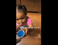 Kid drinking on small cup 