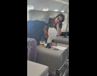 Guy gives dog in in mouth on plane