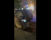 Person working on thrown out recliner chair