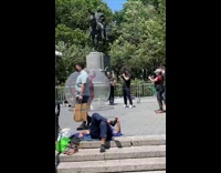Lady in red dress walks around inside bubble 
