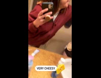 Girl slaps cheese slice on guys face