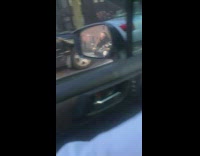 Guy rides scooter holding dog 