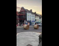 Two hay bale roll down the road