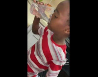 Little kid in red and white shirt eats jalapeño