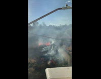 Guy looks out window sees brush on fire 